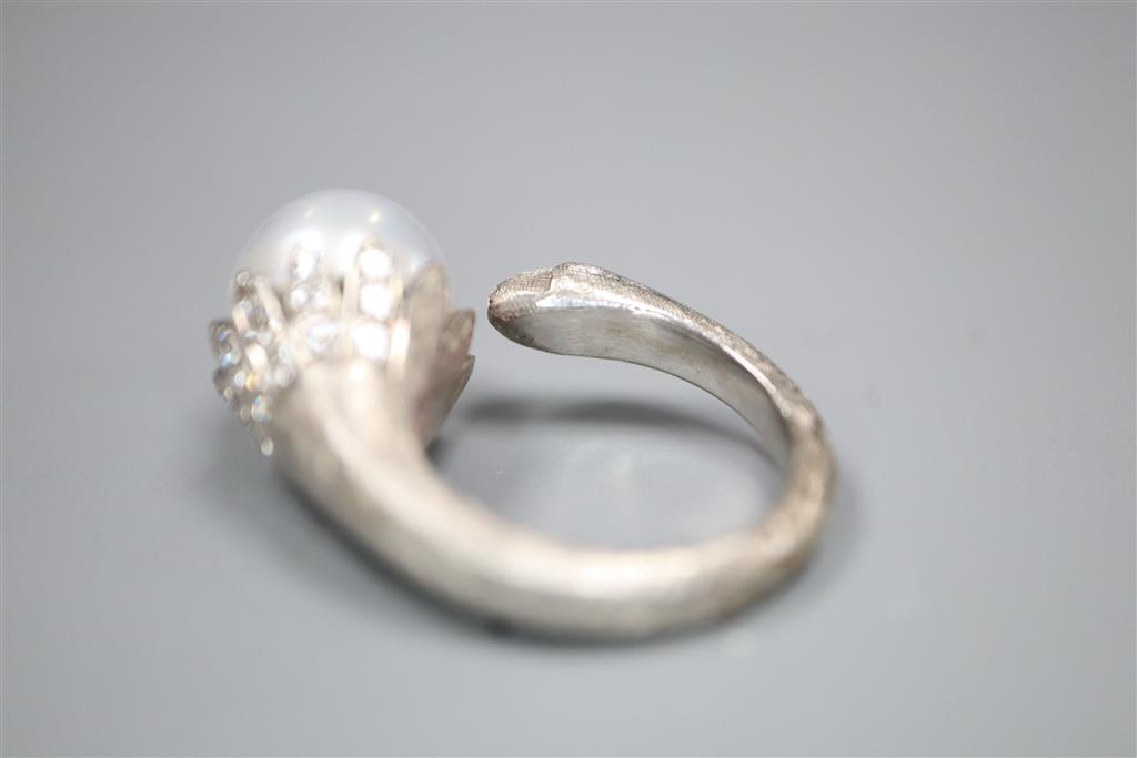 A modern textured white metal (possibly platinum), cultured pearl and diamond set openwork dress ring,